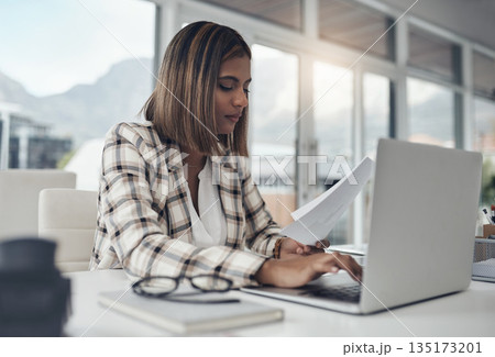 Business analyst, laptop and woman typing paperwork in office workplace. Documents analysis, computer and female person reading, working and analyzing data, graphs or charts for finance statistics. Business analyst, laptop and woman typing paperwork in office workplace. Documents analysis, computer and female person reading, working and analyzing data, graphs or charts for finance statistics. 135173201