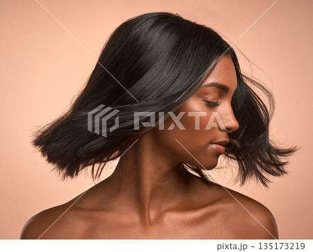 Hair care, beauty and young woman in studio with keratin, healthy or brazilian salon treatment. Wellness, cosmetic and female model with motion for shiny, clean and soft hairstyle by brown background 135173219