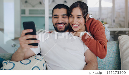 Phone, happy and couple with smile on sofa for social media post, online website and internet. Communication, relationship and man and woman relax on smartphone for quality time, bonding and network Phone, happy and couple with smile on sofa for social media post, online website and internet. Communication, relationship and man and woman relax on smartphone for quality time, bonding and network 135173300
