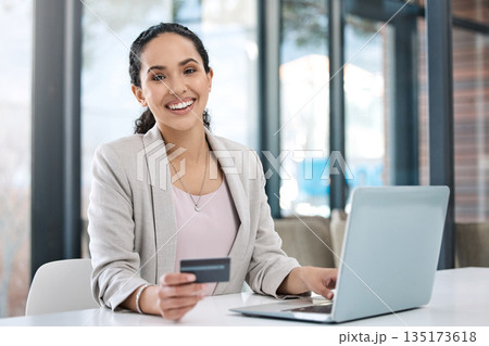 Business woman, laptop online shopping and portrait with happiness and credit card. Paying bills, happy worker and ecommerce purchase of employee banking with website payment at a desk with computer Business woman, laptop online shopping and portrait with happiness and credit card. Paying bills, happy worker and ecommerce purchase of employee banking with website payment at a desk with computer 135173618