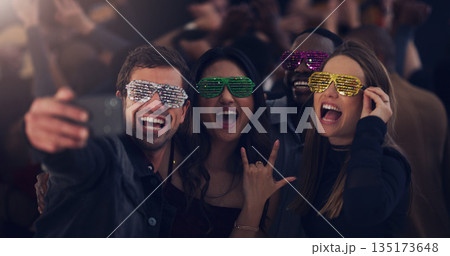 Selfie, sunglasses and friends at party for celebration, festival and dance at social event. Night club, disco and happy men and women take picture for memories, post and celebrate new years eve 135173648