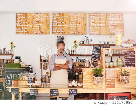 Black man, portrait and owner with arms crossed in cafe with pride for career or job. Barista, smile and confidence of African person from Nigeria in restaurant, small business and coffee shop. Black man, portrait and owner with arms crossed in cafe with pride for career or job. Barista, smile and confidence of African person from Nigeria in restaurant, small business and coffee shop. 135173956