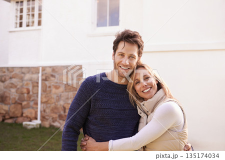 New home, outdoor portrait and happy couple hug for house, real estate and property purchase, sale or investment. Mortgage, happiness and smiling woman, man or homeowner people embrace for relocation 135174034
