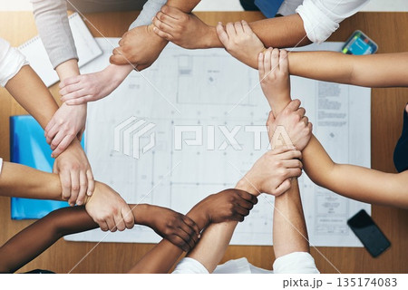 Hands together, above staff and blueprint of people with collaboration and architecture project. Architect team, diversity and paperwork of partnership and teamwork group from above with support Hands together, above staff and blueprint of people with collaboration and architecture project. Architect team, diversity and paperwork of partnership and teamwork group from above with support 135174083