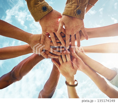 Bottom, people and hands in support of collaboration, trust or solidarity on blue sky background. Teamwork, friends and low angle hand of person group outdoor for team building, partnership or goal Bottom, people and hands in support of collaboration, trust or solidarity on blue sky background. Teamwork, friends and low angle hand of person group outdoor for team building, partnership or goal 135174149