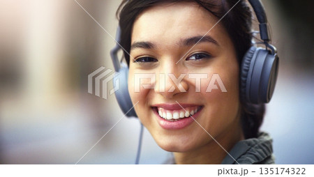 Woman in portrait, headphones in city and smile listening to music, freedom and technology outdoor. Mockup space, podcast or radio streaming with happy female person, urban and audio playlist Woman in portrait, headphones in city and smile listening to music, freedom and technology outdoor. Mockup space, podcast or radio streaming with happy female person, urban and audio playlist 135174322