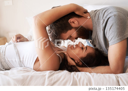 Couple, bed and embrace with face, smile and together in morning for romance, love and bonding in home. Young man, woman and happiness in bedroom with care, support and conversation at apartment Couple, bed and embrace with face, smile and together in morning for romance, love and bonding in home. Young man, woman and happiness in bedroom with care, support and conversation at apartment 135174405