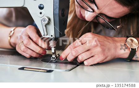 Sewing machine, woman hands and creative fashion designer with button and thread work. Small business, entrepreneur and female tailor with boutique and employee working with machinery for clothing 135174588