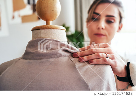 Fashion, hand of woman and tailor with mannequin, focus and creative small business boutique. Closeup, creativity and designer sewing dress on doll for clothes, working in studio or textile start up. 135174628