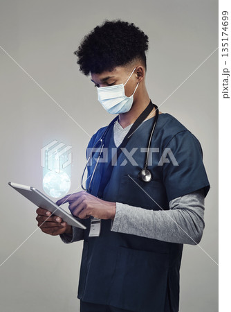 Man, doctor and digital tablet for global communication or healthcare research with covid mask. Male medical expert on technology for data, networking or hologram against a grey studio background Man, doctor and digital tablet for global communication or healthcare research with covid mask. Male medical expert on technology for data, networking or hologram against a grey studio background 135174699