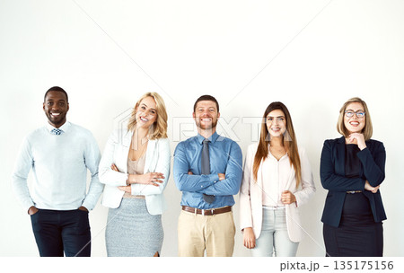 Group, portrait and business people with arms crossed by white wall background mockup space in office. Face, confident smile and employees standing together with teamwork, diversity and collaboration 135175156