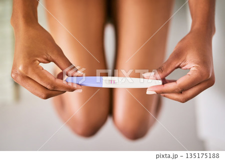 Health, hands and closeup of a positive pregnancy test by a woman in the bathroom of her home. Maternity, motherhood and zoom of a female person with a pregnant stick with results in her modern house Health, hands and closeup of a positive pregnancy test by a woman in the bathroom of her home. Maternity, motherhood and zoom of a female person with a pregnant stick with results in her modern house 135175188