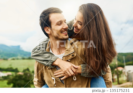 Date, love and piggyback with couple in nature for happy, smile and bonding. Happiness, relax and care with man carrying woman in countryside field for spring, anniversary vacation and travel 135175231