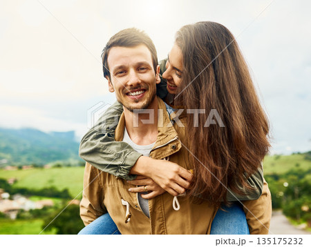 Relax, love and piggyback with couple in nature for happy, smile and bonding. Happiness, playful and care with portrait of man carrying woman on countryside date for spring, vacation and support 135175232