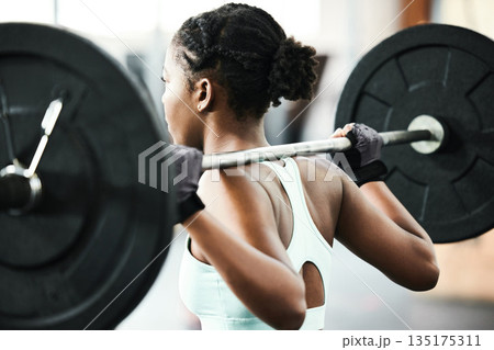 Black woman, back with weightlifting and fitness, barbell in gym and strong bodybuilder with muscle training. Sport, workout and bodybuilding, female athlete in exercise studio, challenge and power Black woman, back with weightlifting and fitness, barbell in gym and strong bodybuilder with muscle training. Sport, workout and bodybuilding, female athlete in exercise studio, challenge and power 135175311