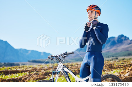 Mountain, helmet and man cycling in a competition, fitness training or sports adventure in summer with blue sky. Gear, athlete and safety in outdoor cycle, bike ride or exercise in nature or park Mountain, helmet and man cycling in a competition, fitness training or sports adventure in summer with blue sky. Gear, athlete and safety in outdoor cycle, bike ride or exercise in nature or park 135175459