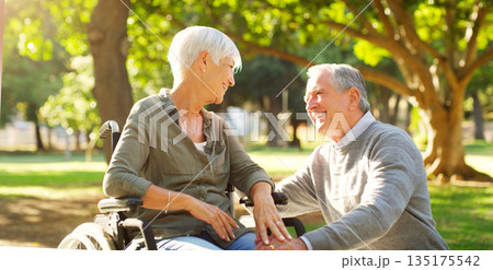 Senior couple, wheelchair and happy outdoor at a park while talking with love, care and respect. A elderly man and woman with disability in nature for quality time, healthy marriage or retirement 135175542