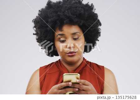 Social media, girl and black woman with a smartphone, attitude and communication on a white studio background. Female person, doubt or model with a cellphone, mobile app and online reading or contact 135175628