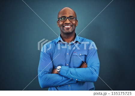 Business, black man and portrait with arms crossed in a studio feeling proud from auditor work. Blue background, smile and African employee with success and leadership vision with glasses and idea Business, black man and portrait with arms crossed in a studio feeling proud from auditor work. Blue background, smile and African employee with success and leadership vision with glasses and idea 135175725