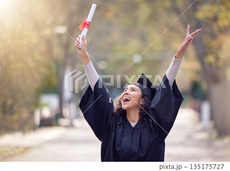 Success, college student graduate and celebration outdoors with a lens flare. Victory or education, university and happy woman cheering for achievement on her graduation day with certificate 135175727