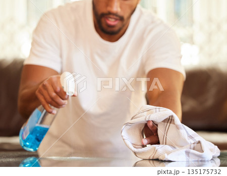Man, clean table with chemical and cloth, detergent spray and wipe dirt from furniture. Housekeeping, male person cleaning home with bottle and disinfecting surface from bacteria with hygiene Man, clean table with chemical and cloth, detergent spray and wipe dirt from furniture. Housekeeping, male person cleaning home with bottle and disinfecting surface from bacteria with hygiene 135175732