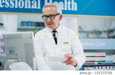 Pharmacy product, cash register and senior man process sale of pharmaceutical, supplements or pills box. Retail pharmacist, drug store medicine and medical person enter prescription package data Pharmacy product, cash register and senior man process sale of pharmaceutical, supplements or pills box. Retail pharmacist, drug store medicine and medical person enter prescription package data 135175780