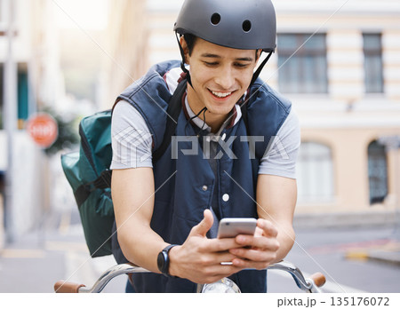 Man, courier bicycle and smile with phone, order or e commerce app for food, product and sustainable transport. Young guy, bike and metro street with texting, chat and eco friendly with logistics job 135176072
