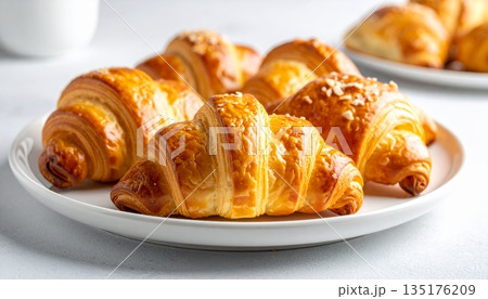 Deliciously fresh croissants on a white plate. 135176209