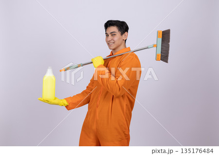 Janitor in orange uniform holding mop Janitor in orange uniform holding mop 135176484