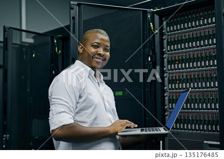 Server room, black man or portrait of technician with laptop for online cyber security glitch or software. IT support, happy or friendly African engineer fixing network for information technology Server room, black man or portrait of technician with laptop for online cyber security glitch or software. IT support, happy or friendly African engineer fixing network for information technology 135176485