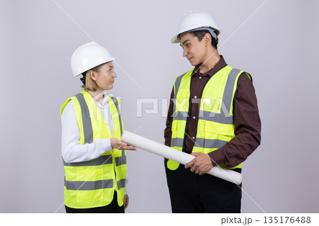 Male and female engineers discussing plan 135176488