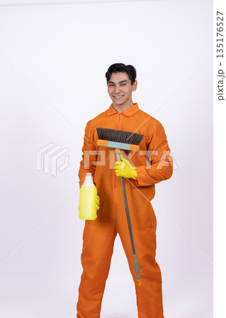 Male cleaner in orange uniform standing Male cleaner in orange uniform standing 135176527