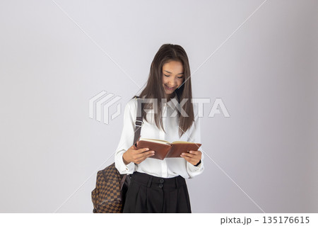 Woman in black t-shirt with backpack Woman in black t-shirt with backpack 135176615
