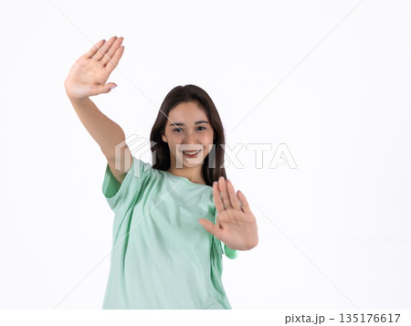 Girl in green t-shirt waving hand Girl in green t-shirt waving hand 135176617