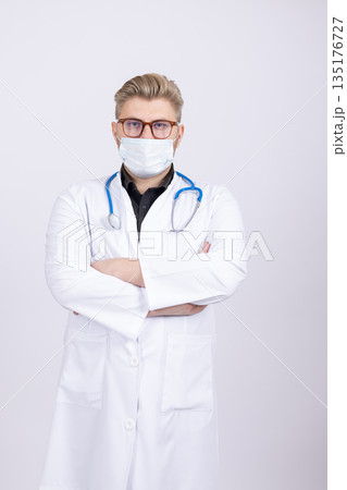 Confident male doctor in a white lab coat Confident male doctor in a white lab coat 135176727