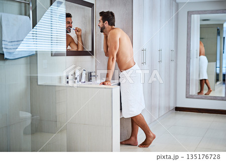 Man brushing teeth in bathroom at mirror for dental wellness, healthy habit and gums. Shirtless guy, shower and cleaning mouth for fresh breath, oral hygiene and morning routine for grooming at home Man brushing teeth in bathroom at mirror for dental wellness, healthy habit and gums. Shirtless guy, shower and cleaning mouth for fresh breath, oral hygiene and morning routine for grooming at home 135176728