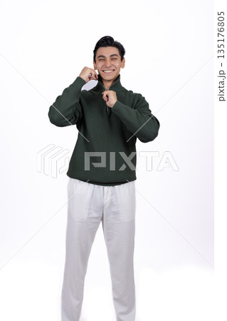 Man in a green sweatshirt holding a coffee cup 135176805