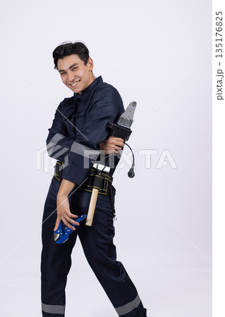 Repairman in a blue uniform with tools on his belt 135176825