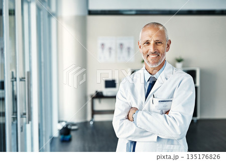 Mature doctor, worker and portrait with arms crossed in hospital feeling proud from medical work. Healthcare, wellness and physician employee smile with happiness from health support and mockup 135176826