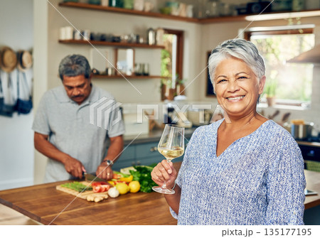 Portrait of old woman in kitchen with man, wine and cooking healthy food together in home. Bonding, smile and senior couple in house with meal prep, happiness and drinks to relax in retirement time. 135177195