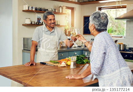 Cheers, wine and old couple in kitchen, cooking healthy food together with smile, diet and health. Toast, senior woman and man with drinks in glass, meal prep and happiness with love in retirement. Cheers, wine and old couple in kitchen, cooking healthy food together with smile, diet and health. Toast, senior woman and man with drinks in glass, meal prep and happiness with love in retirement. 135177214