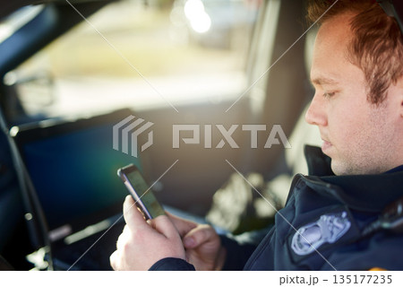 Police, officer and man texting with phone in patrol car for security contact, law enforcement update and mobile notification. Policeman typing message on cellphone for crime news, connection and app Police, officer and man texting with phone in patrol car for security contact, law enforcement update and mobile notification. Policeman typing message on cellphone for crime news, connection and app 135177235