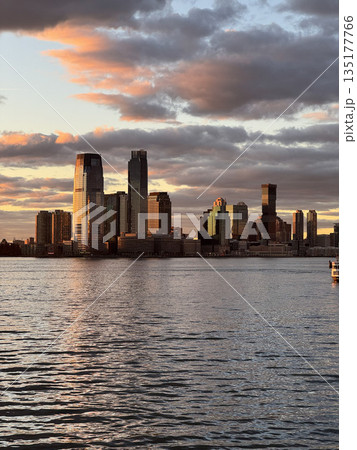 Stunning Sunset Over New York City Skyline Reflected in Water Stunning Sunset Over New York City Skyline Reflected in Water 135177766