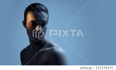 Male upper body portrait with soft blue light and shadows. Male upper body portrait with soft blue light and shadows. 135178335