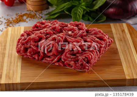 Raw minced beef meat over board Raw minced beef meat over board 135178439