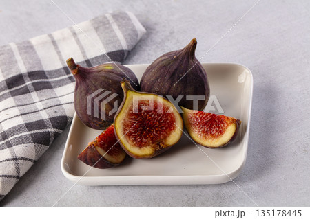 Ripe juicy sweet purple fig 135178445