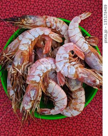 A bowl of shrimp with a green bowl 135178489