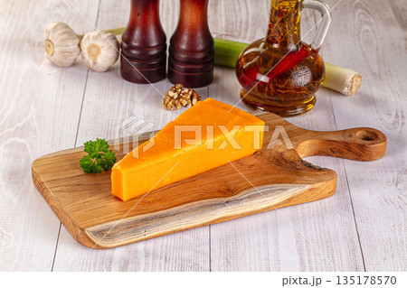 Yellow cheddae cheese over board Yellow cheddae cheese over board 135178570