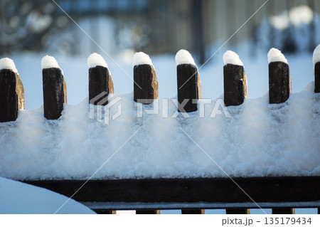 Fresh snow on the fence 135179434