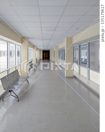 Empty Modern Hospital Hallway with Metal Benches and Bright Windows 135179617